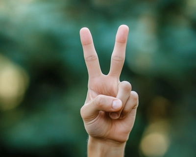 a peace sign for kindness and autism