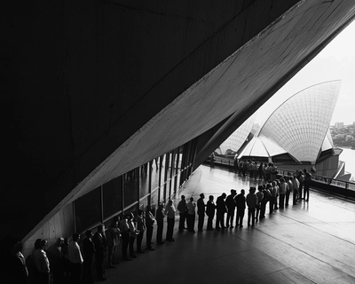 Sydney opera house with people lined up to get in 