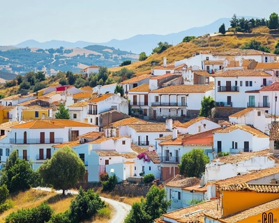 Instructions: Below, you'll find descriptions of adjectives in English. Fill in the crossword puzzle by writing the correct Spanish adjective from the word bank. Use the word bank to help you. Each word should only be used once.

Word Bank
abandonado, acogedor, agradable, antiguo, bullicioso, cálido, caótico, costero, despejado, encantador, famoso, frondoso, grande, hediondo, histórico, industrial, llano, montañoso, peligroso, pintoresco

Across
1. An adjective for a place that has been left and not cared for.
2. A word to describe a place that makes people feel comfortable and welcomed.
3. Describes a place that is enjoyable to be in, pleasant.
4. This word refers to a place that is very old.
5. Used for a place that is noisy and full of activity.
6. Describes a place that feels warm, both in temperature and atmosphere.
7. An adjective for a chaotic and disorganized place.
8. Describes a place that is near the sea.
9. A place that is clear of clouds or obstacles.
10. A place that is charming and delightful.

Down
11. Describes a place that is well-known or famous.
12. A place that is full of lush green trees and vegetation.
13. A word for a very large place.
14. Describes a place that smells bad.
15. Refers to a place that has great historical significance.
16. An adjective for a place full of factories and industry.
17. A place that is flat and level.
18. Describes a place that has many mountains.
19. A word for a place that is dangerous.
20. An adjective for a place that is visually attractive, often because of its charm or quaintness.
